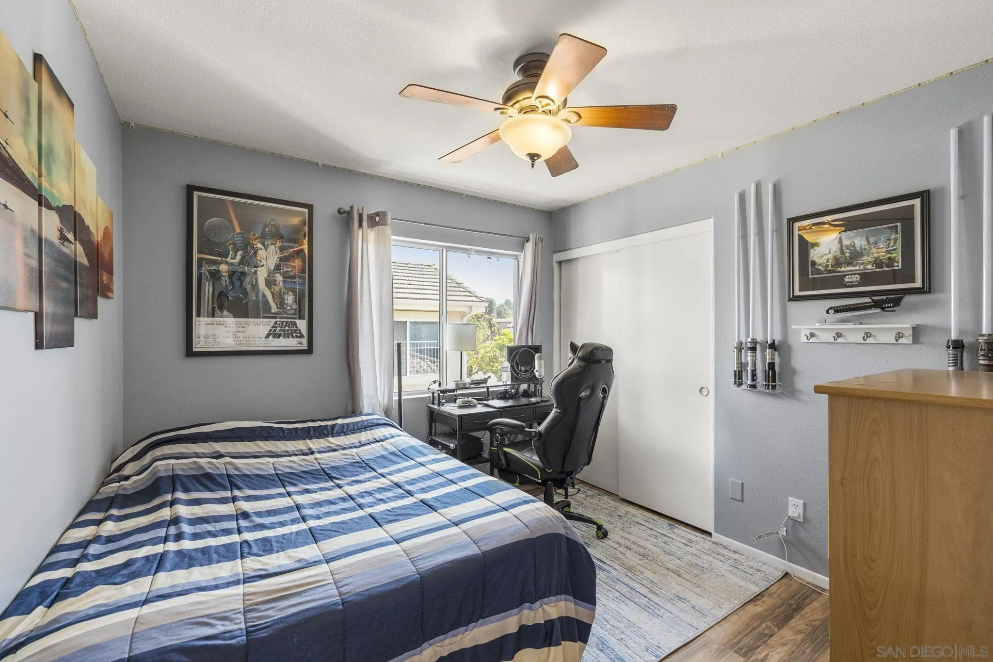 838 Masters Drive Oceanside, CA 92057 - Photo 23 of 39 a bedroom with a bed and wooden floor