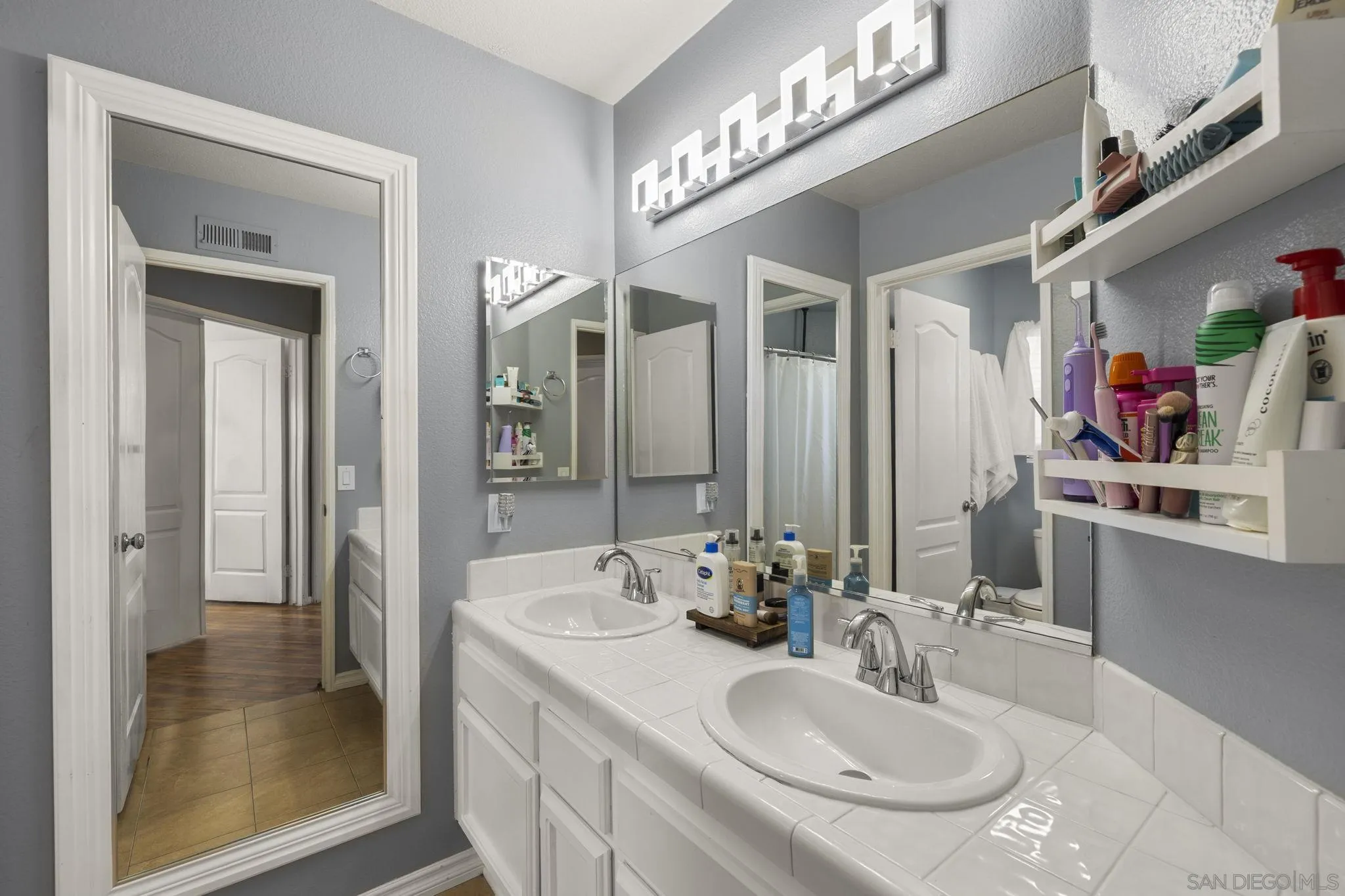 838 Masters Drive Oceanside, CA 92057 - Photo 24 of 39 a bathroom with a sink and a mirror