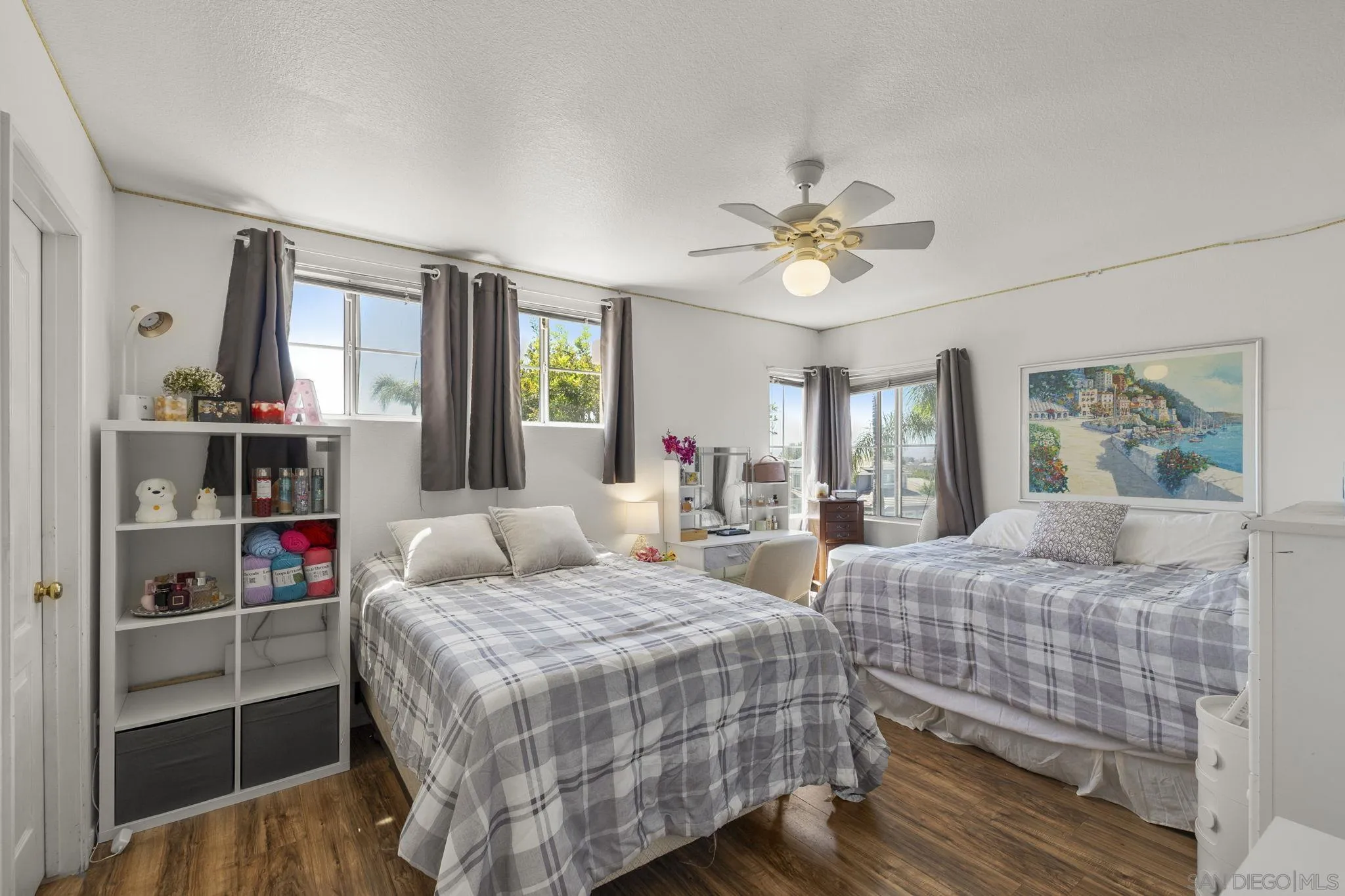 838 Masters Drive Oceanside, CA 92057 - Photo 25 of 39 a bedroom with two beds and a chandelier