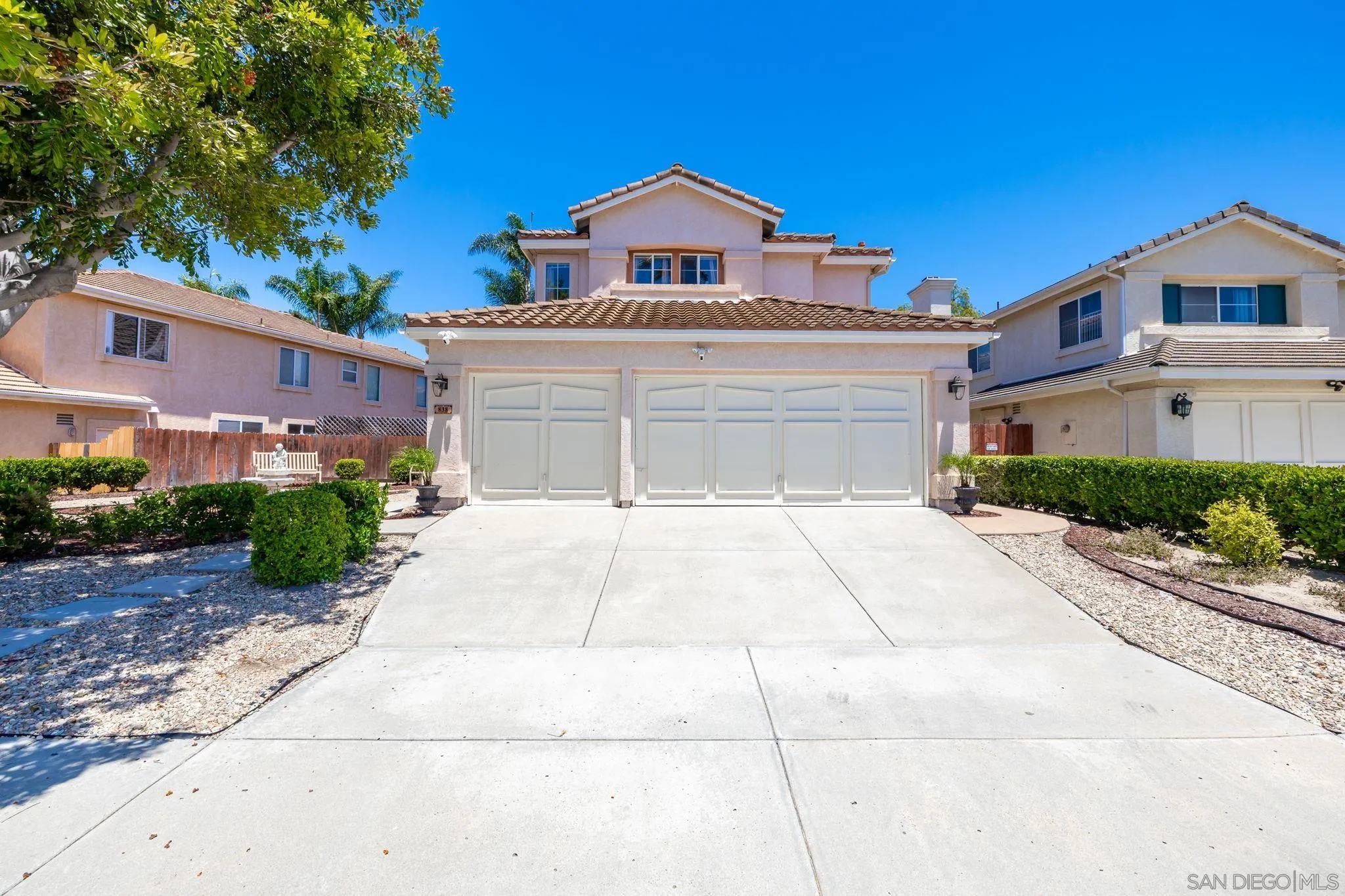 838 Masters Drive Oceanside, CA 92057 - Photo 27 of 39 a front view of a house with a yard and garage