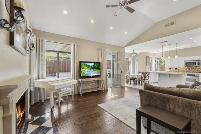 a living room with furniture a fireplace and a flat screen tv