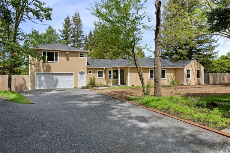 62 Randall Lane Santa Rosa, CA 95409 - Photo 1 of 1 a front view of a house with a yard and a garage