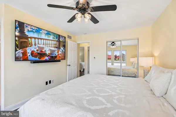a bedroom with a bed and a large window