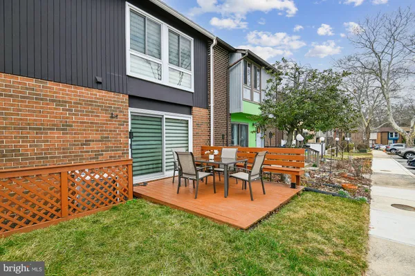 a view of a patio with table and chairs with wooden fence and plants