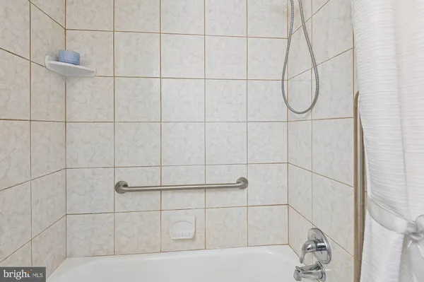 a bathroom with a shower and a window