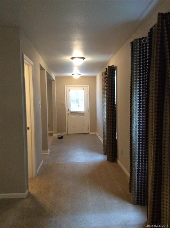 5409 Idlewild Road North Charlotte, NC 28227 - Photo 2 of 10 an empty room with windows and closet