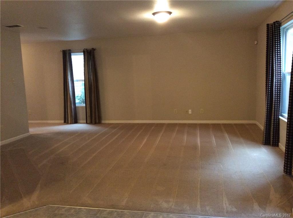 5409 Idlewild Road North Charlotte, NC 28227 - Photo 5 of 10 an empty room with wooden floor and windows