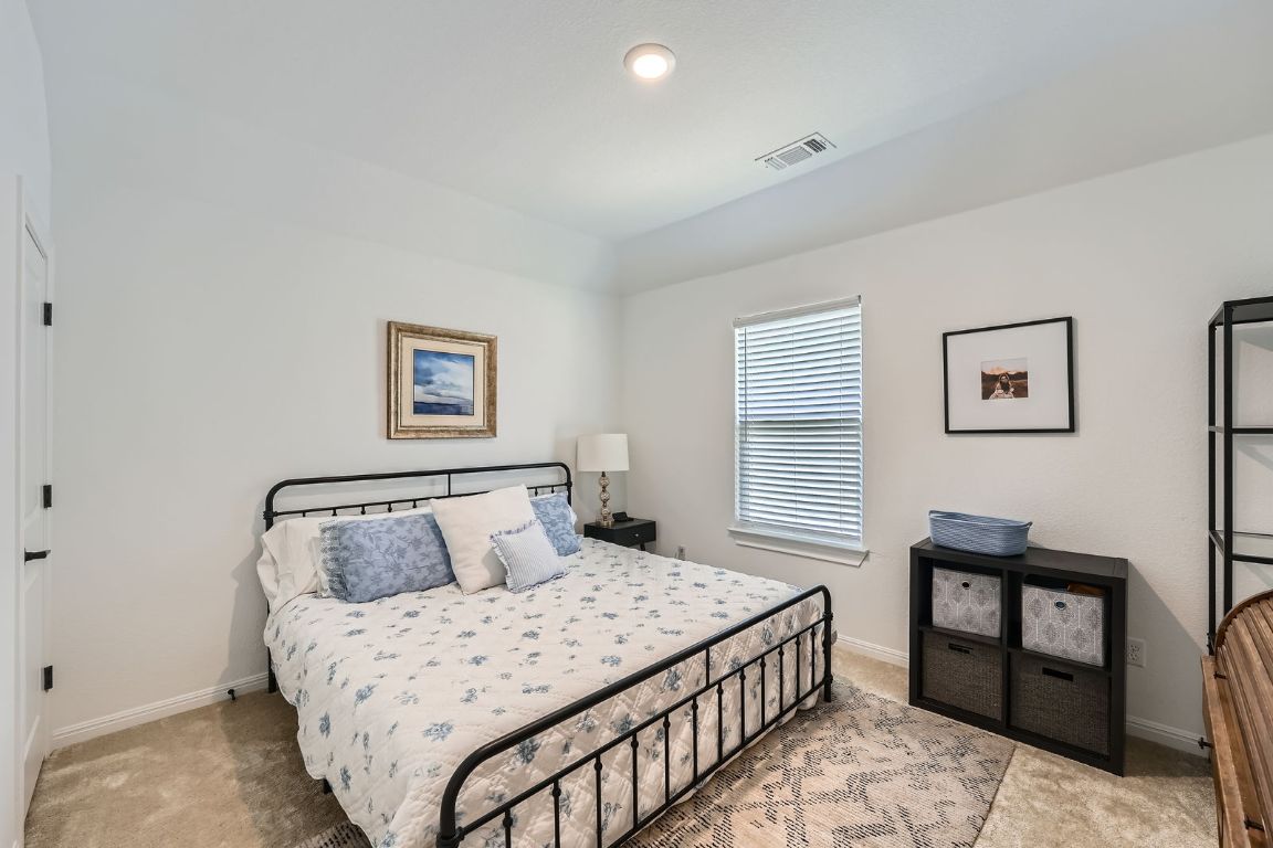 321 Georgia Lace Trail Georgetown, TX 78626 - Photo 17 of 28 Bedroom featuring light colored carpet and baseboards