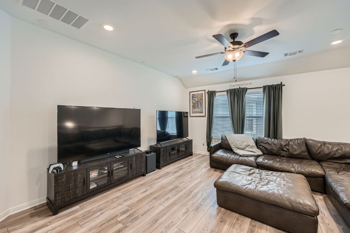 321 Georgia Lace Trail Georgetown, TX 78626 - Photo 21 of 28 Living area featuring recessed lighting, light wood-style floors, vaulted ceiling, and a ceiling fan