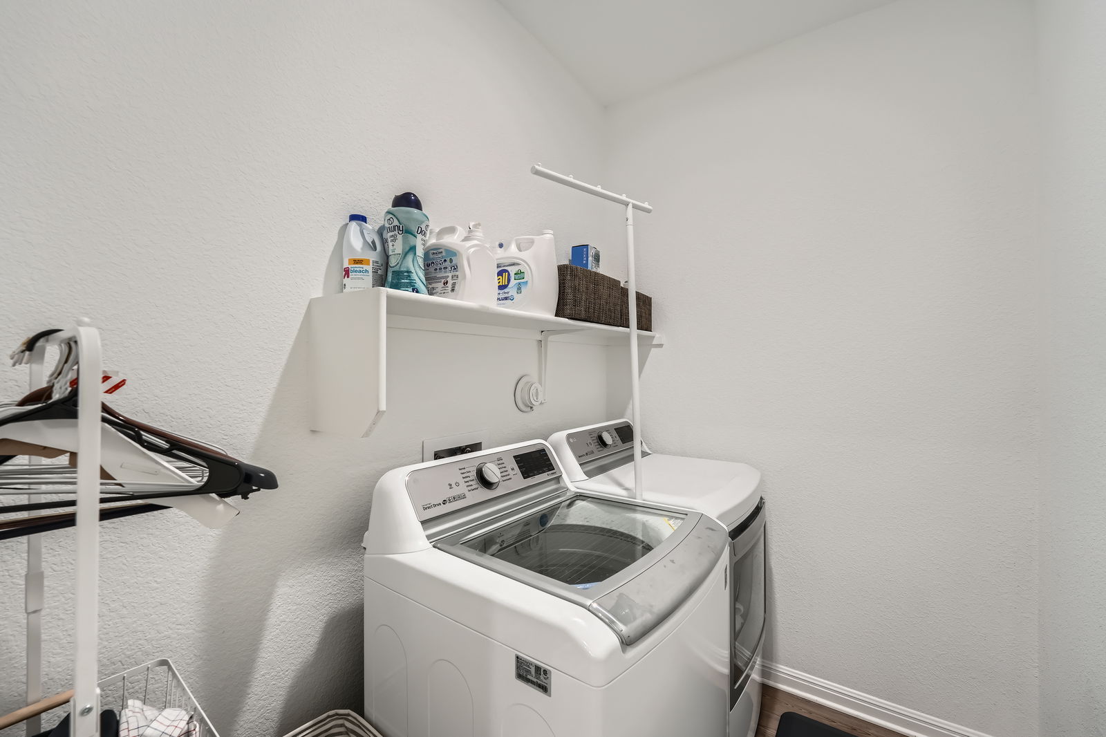 321 Georgia Lace Trail Georgetown, TX 78626 - Photo 21 of 27 Laundry room featuring washer and clothes dryer and a textured wall