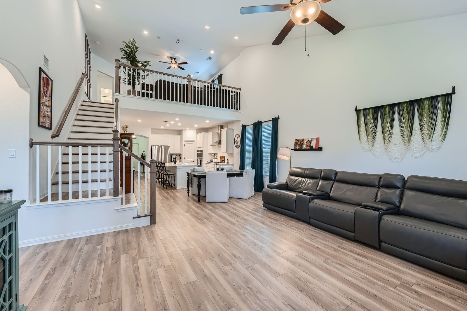 321 Georgia Lace Trail Georgetown, TX 78626 - Photo 4 of 27 Living room featuring light wood-type flooring, stairway, recessed lighting, a ceiling fan, and a towering ceiling
