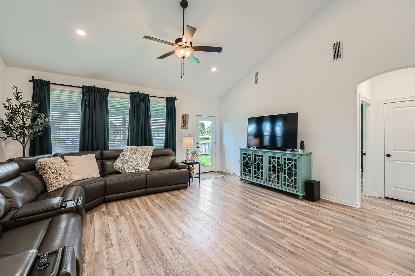 321 Georgia Lace Trail Georgetown, TX 78626 - Photo 5 of 27 Living area with light wood-style flooring, high vaulted ceiling, ceiling fan, arched walkways, and recessed lighting