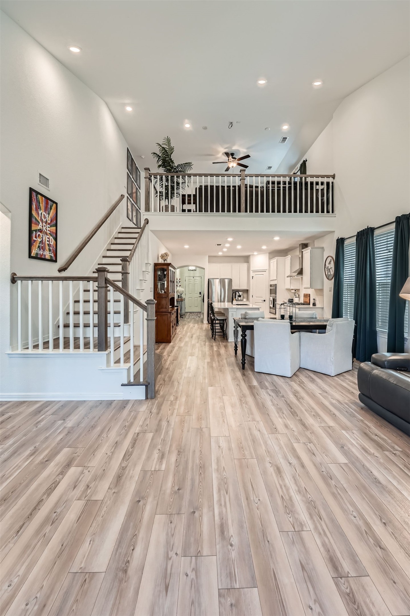 321 Georgia Lace Trail Georgetown, TX 78626 - Photo 6 of 27 Living area with a towering ceiling, light wood-type flooring, stairs, recessed lighting, and a ceiling fan
