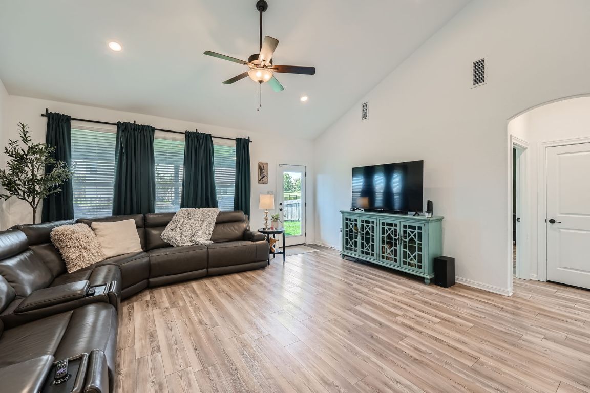 321 Georgia Lace Trail Georgetown, TX 78626 - Photo 6 of 28 Living area with light wood-style flooring, high vaulted ceiling, ceiling fan, arched walkways, and recessed lighting