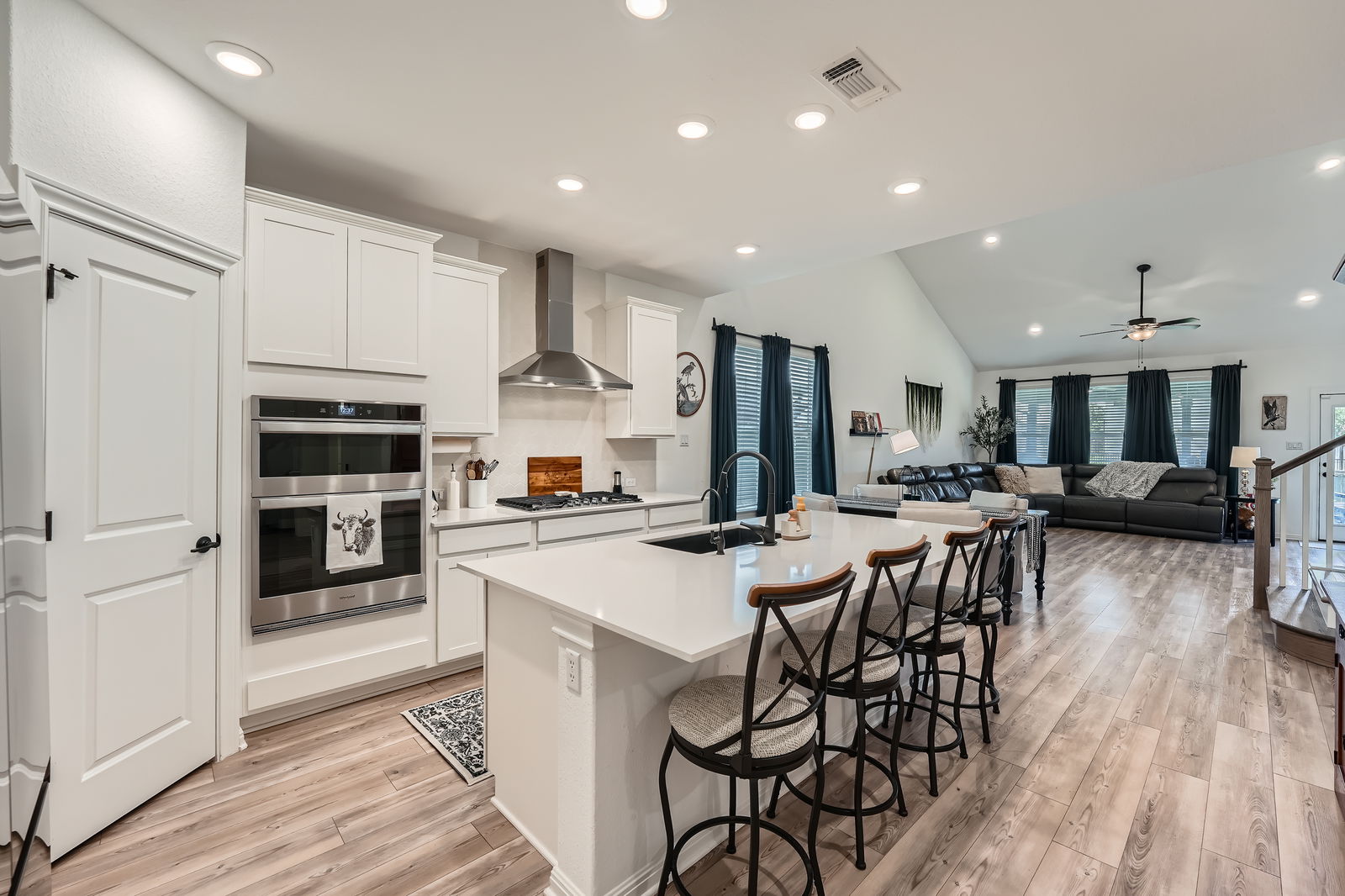 321 Georgia Lace Trail Georgetown, TX 78626 - Photo 26 of 27 Kitchen with recessed lighting, a breakfast bar, lofted ceiling, wall chimney range hood, and open floor plan