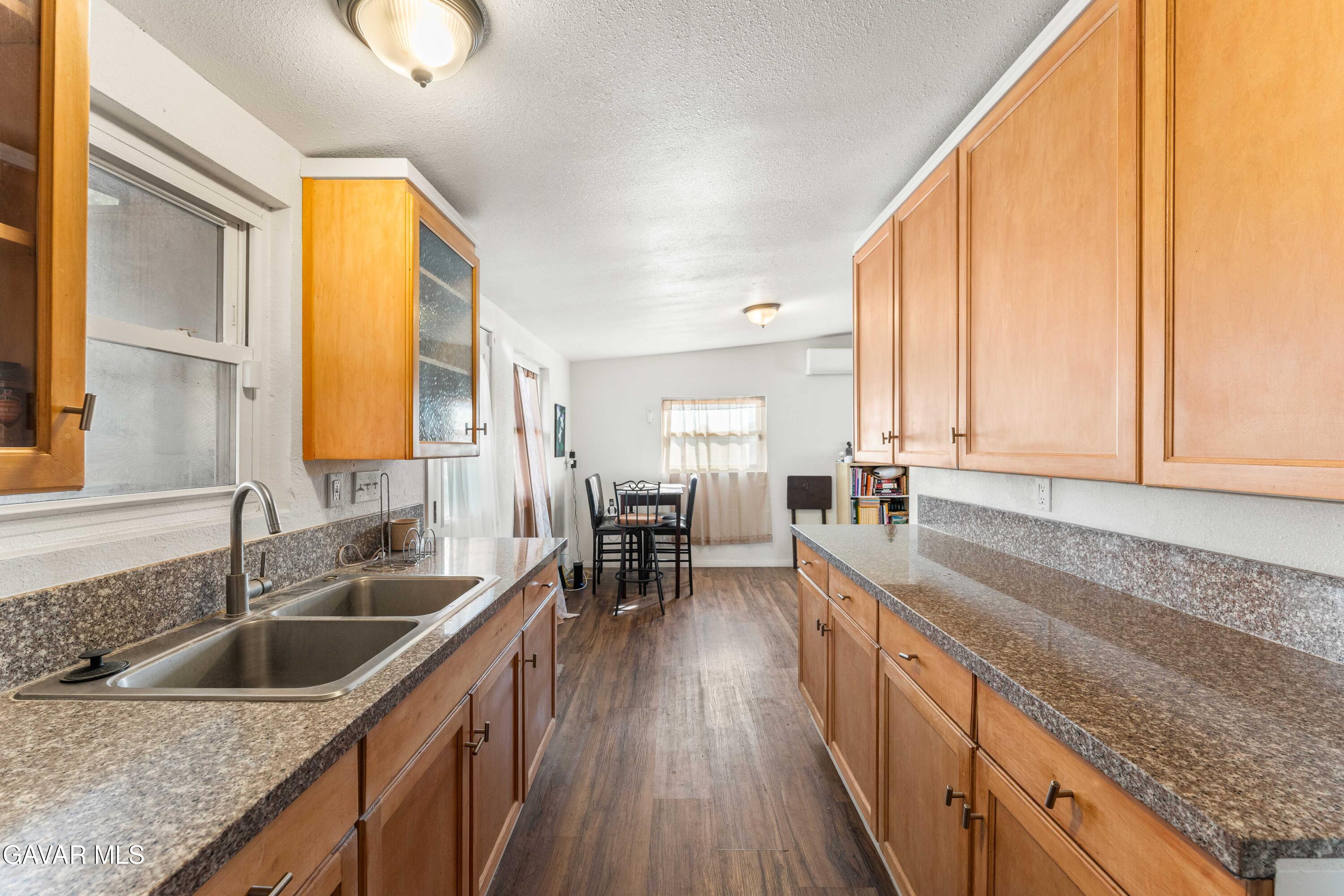 13656 Margo Street North Edwards, CA 93523 - Photo 11 of 24 a kitchen with a sink a counter top space and living room area