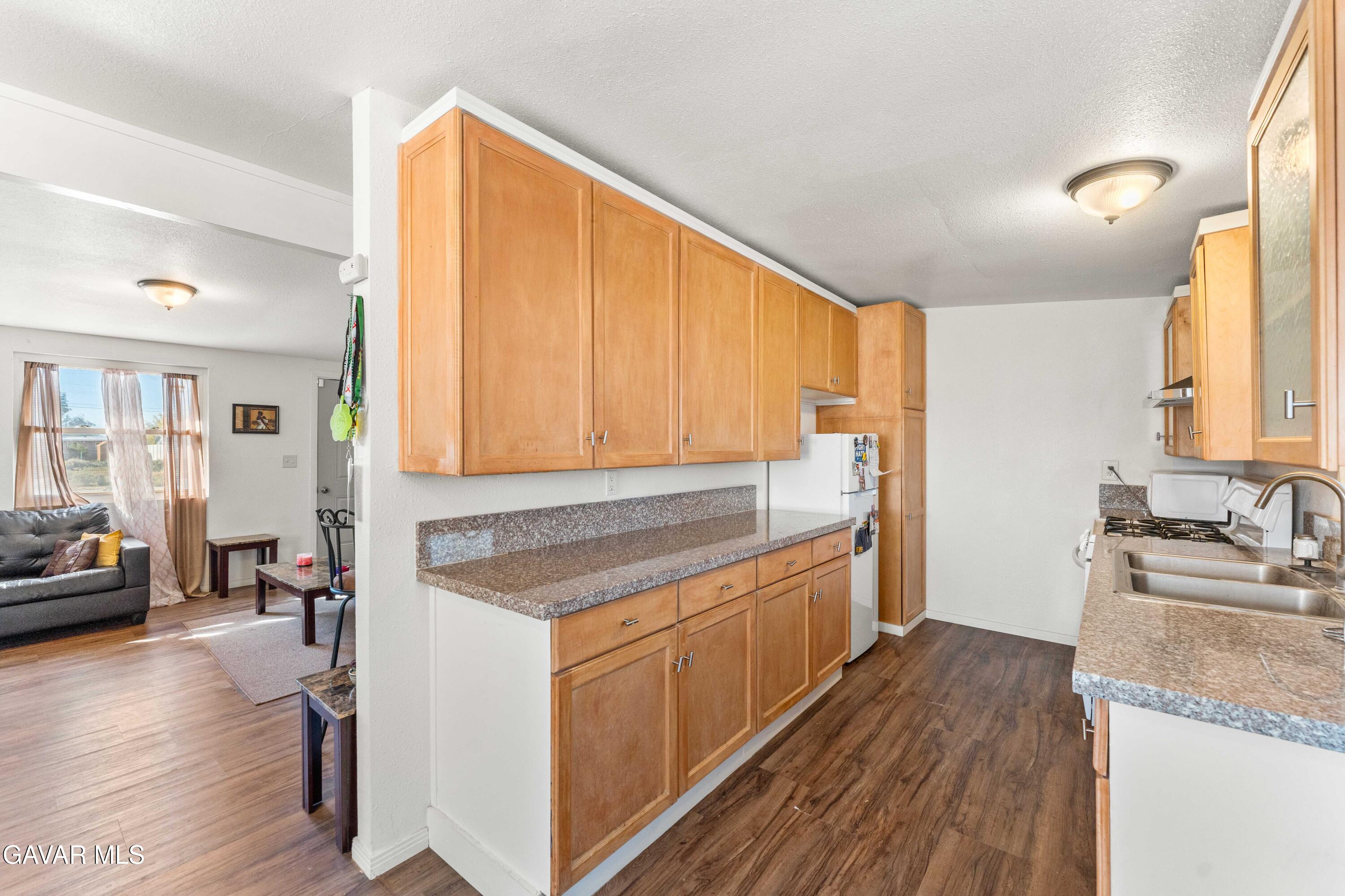 13656 Margo Street North Edwards, CA 93523 - Photo 10 of 24 a kitchen with a sink stove and wooden floor