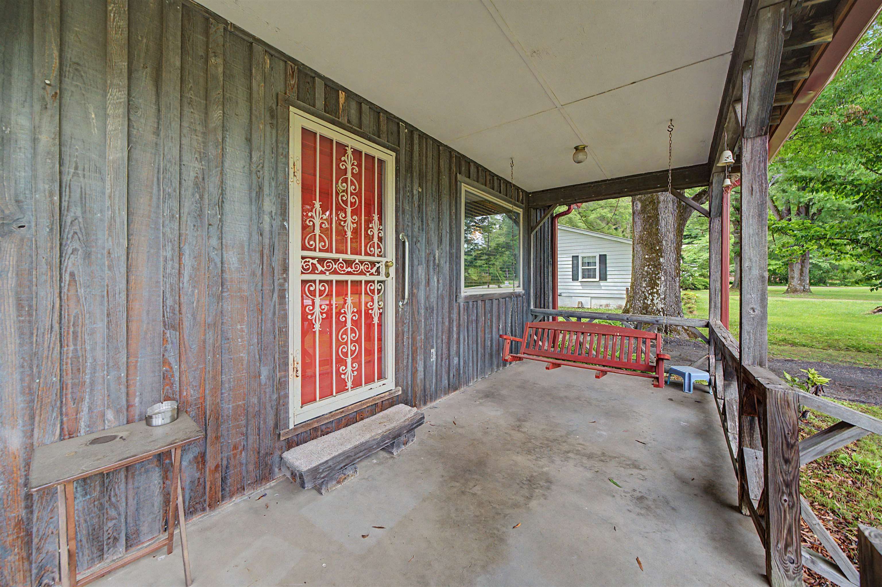 12 Baker Road Selmer, TN 38375 - Photo 8 of 28 a view of a porch with wooden floor and front door