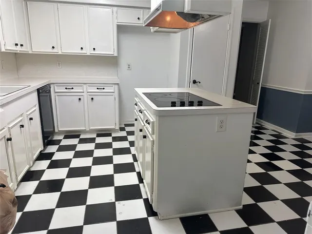 a kitchen with a sink a stove a refrigerator and cabinets