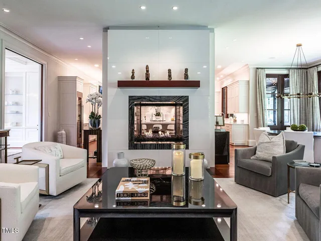 a view of staircase with lots of frames on wall and a window