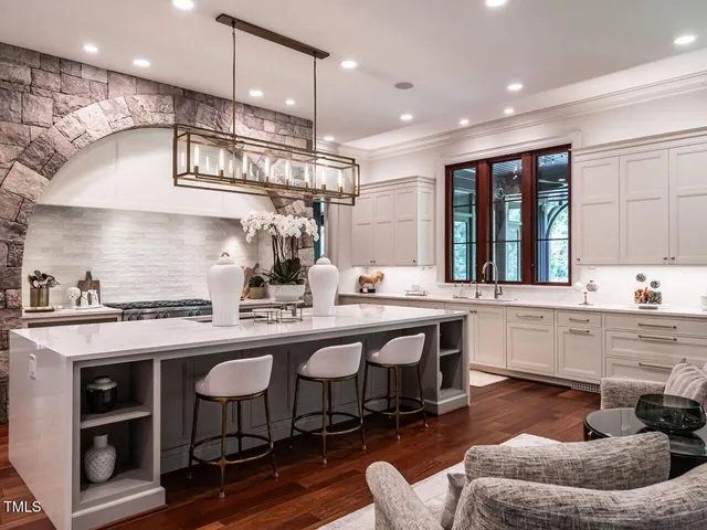 a bathroom with a granite countertop sink a toilet a mirror and shower