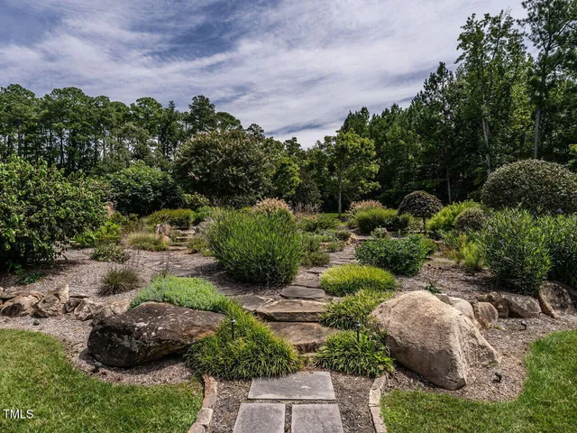 a front view of a house with outdoor seating and plants
