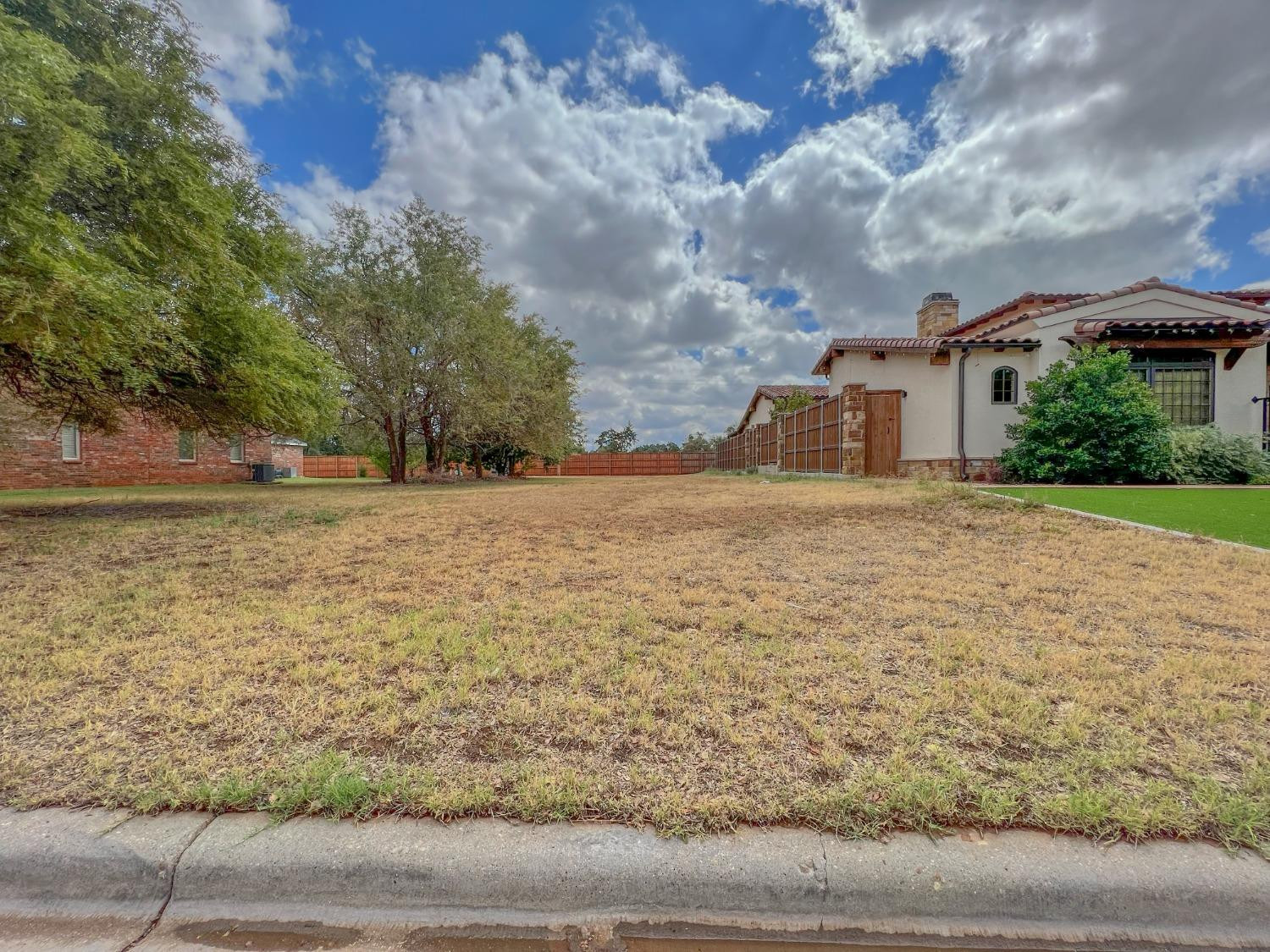 5227 21st Street Lubbock, TX 79407 - Photo 2 of 4 a view of a yard with an trees