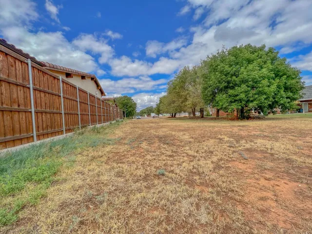 a view of an outdoor space with wooden fence