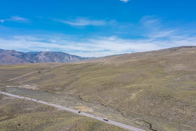 a view of a yard with mountains in the background
