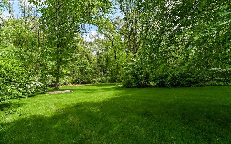 Mature trees surround the yard for privacy