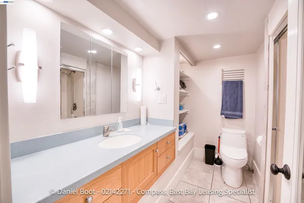a bathroom with a granite countertop shower sink and mirror