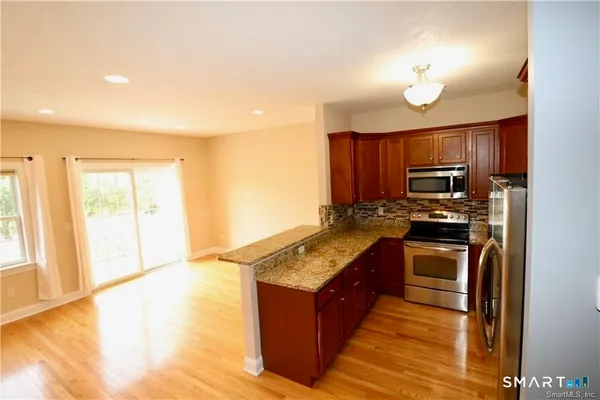 a kitchen with granite countertop cabinets and steel stainless steel appliances