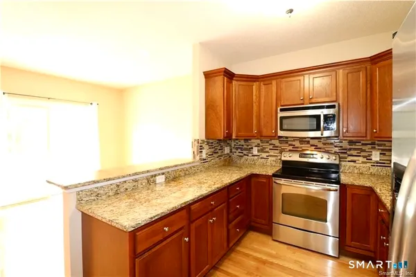 a kitchen with a sink stove and microwave