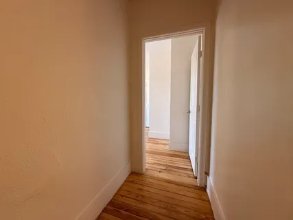 a view of a room with wooden floor