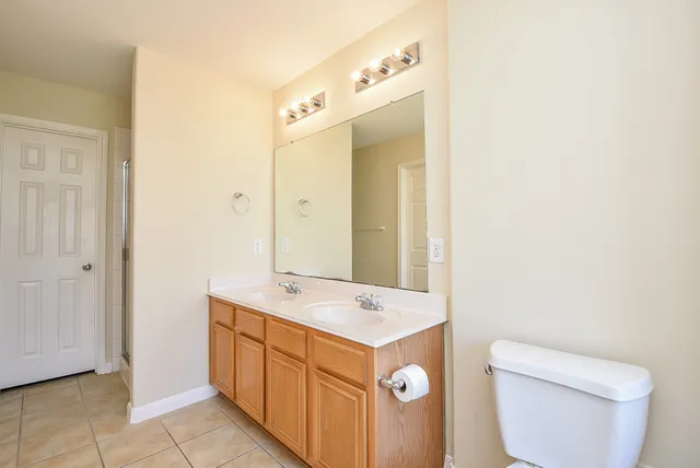a view of bathroom with a toilet sink and mirror