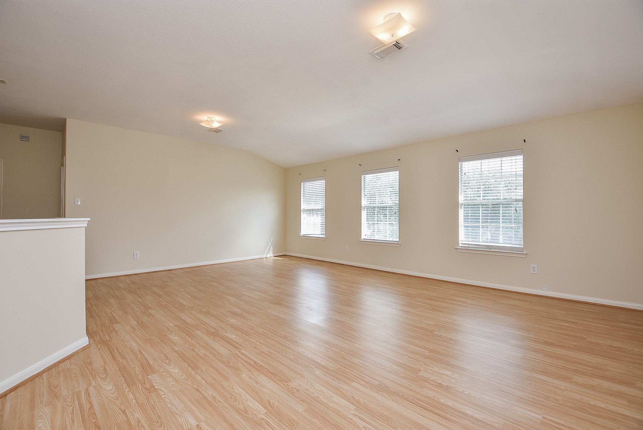 23527 Maple View Drive Spring, TX 77373 - Photo 16 of 25 a view of an empty room with wooden floor and a window