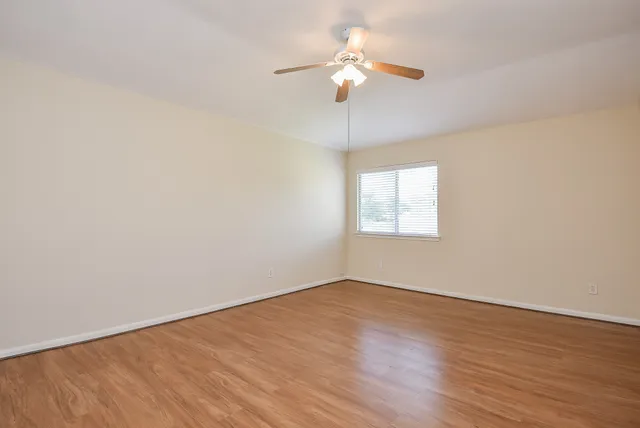 wooden floor in an empty room with a window