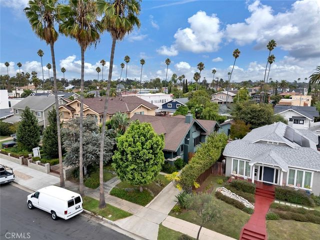 a view of a city street with lots of palm trees