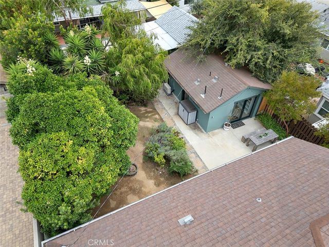 an aerial view of a house with a yard