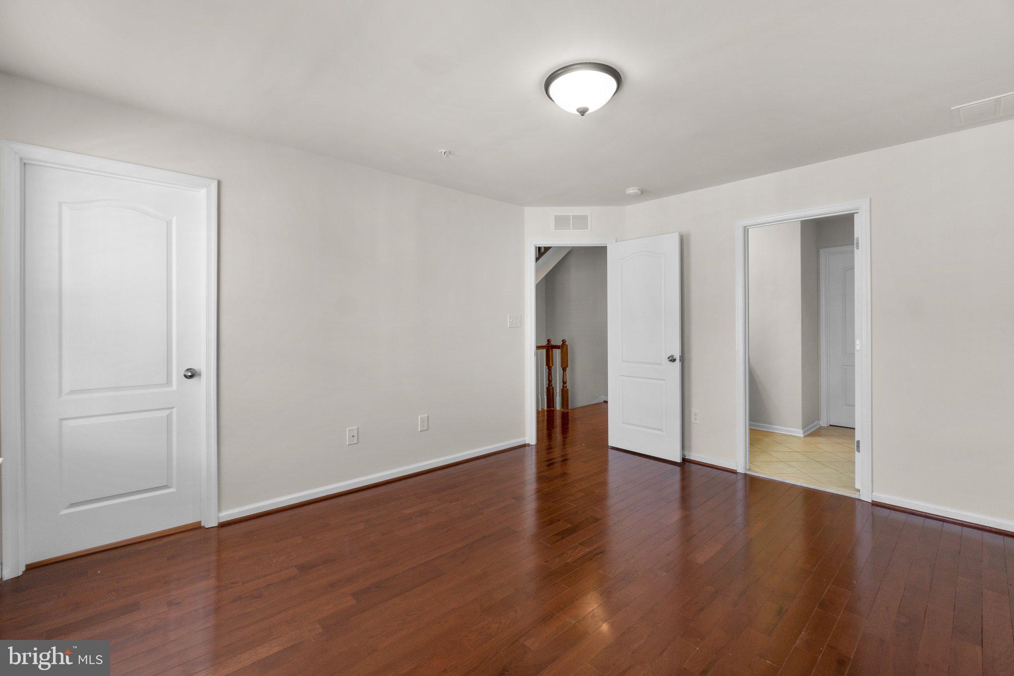 8020 Ravenclaw Road Elkridge, MD 21075 - Photo 13 of 38 a view of an empty room with wooden floor