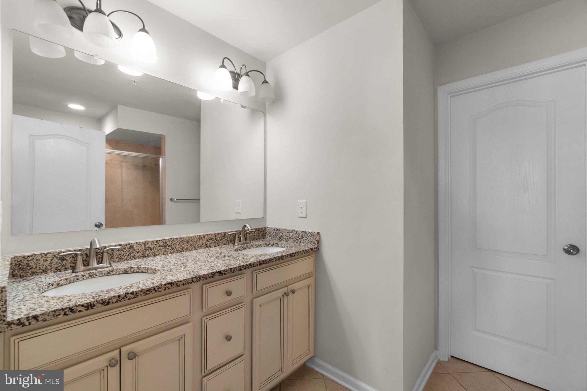 8020 Ravenclaw Road Elkridge, MD 21075 - Photo 15 of 38 a bathroom with a granite countertop sink and a mirror