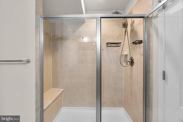 a bathroom with a glass shower door