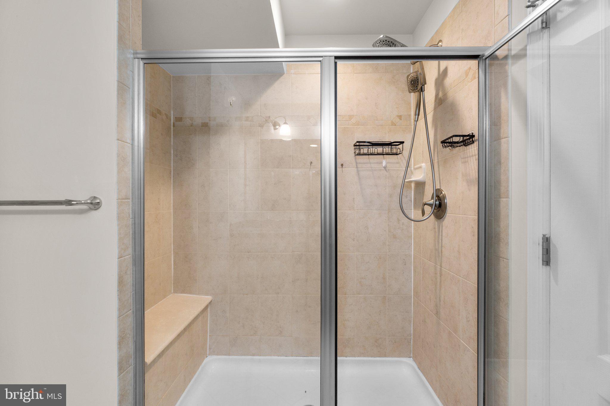 8020 Ravenclaw Road Elkridge, MD 21075 - Photo 16 of 38 a bathroom with a glass shower door