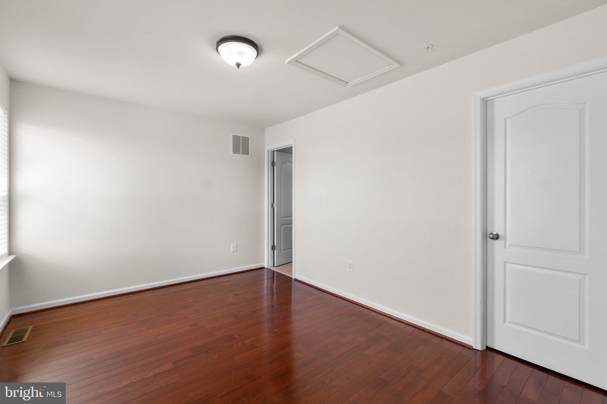 8020 Ravenclaw Road Elkridge, MD 21075 - Photo 23 of 38 an empty room with wooden floor and windows