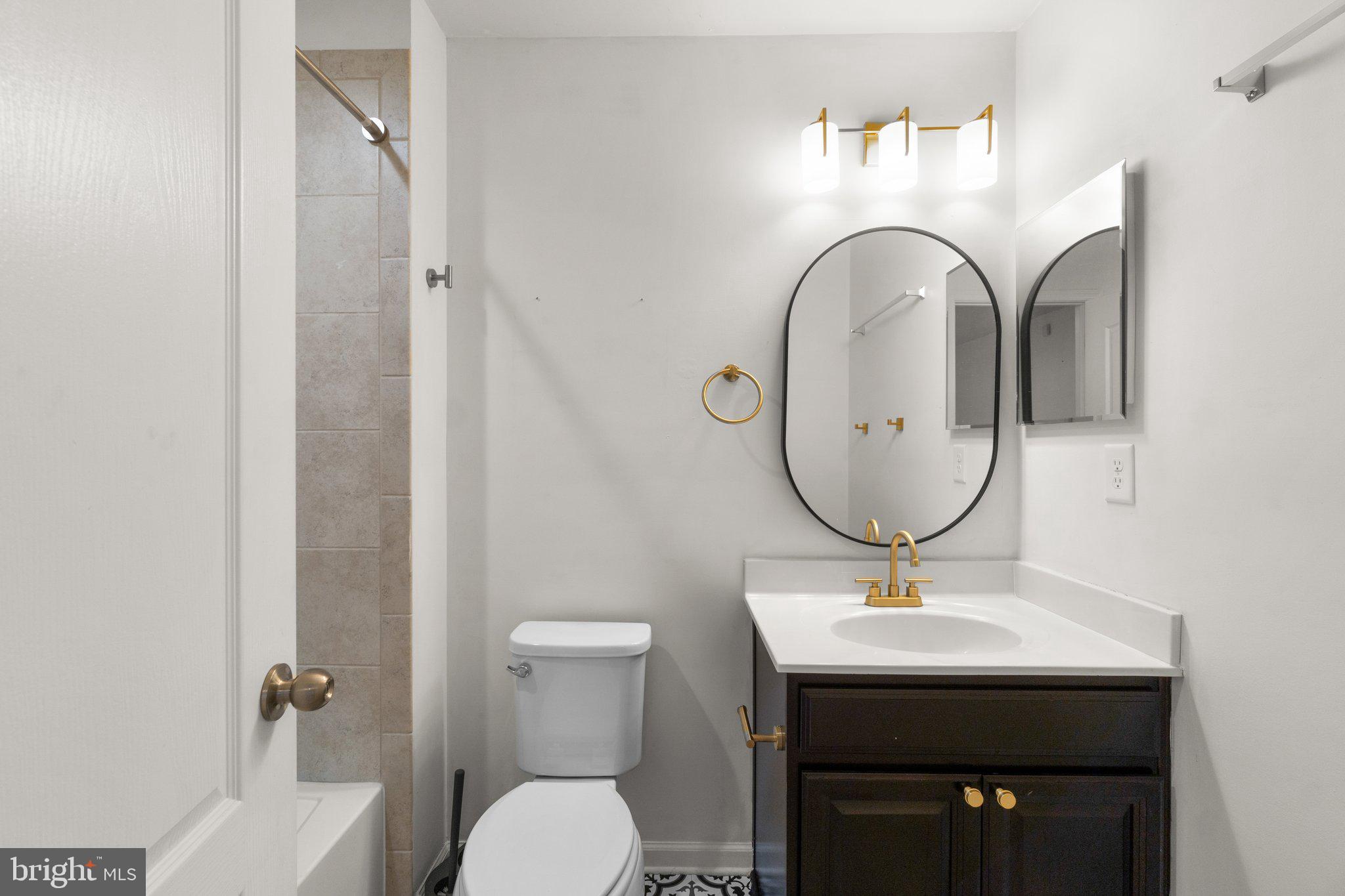 8020 Ravenclaw Road Elkridge, MD 21075 - Photo 28 of 38 a bathroom with a toilet a sink and mirror