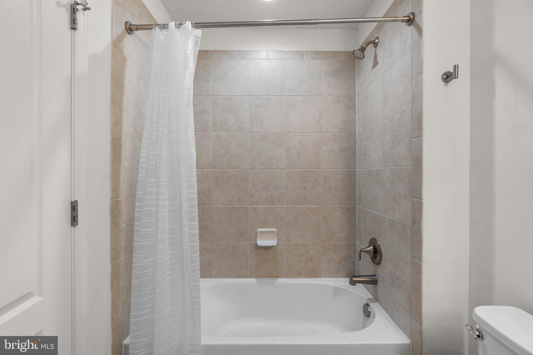 8020 Ravenclaw Road Elkridge, MD 21075 - Photo 29 of 38 a bathroom with a shower and a bath tub