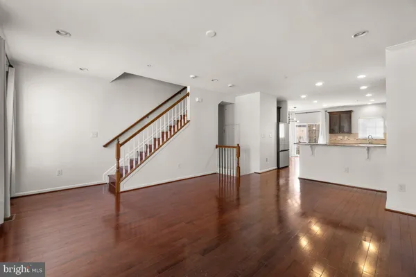 a view of an empty room with wooden floor