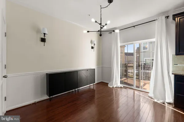 a view of room with wooden floor and window
