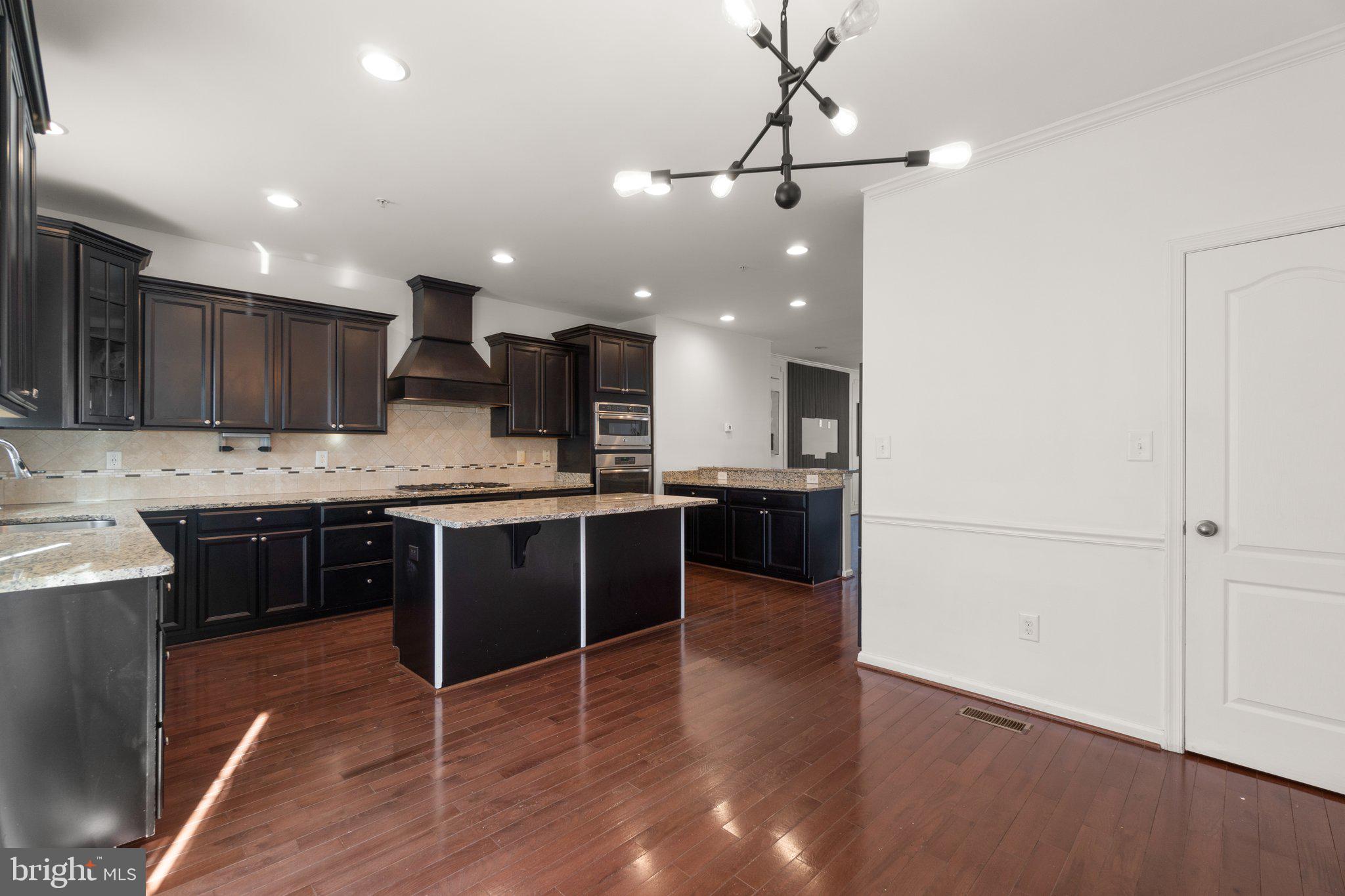 8020 Ravenclaw Road Elkridge, MD 21075 - Photo 10 of 38 a large kitchen with a center island appliances and cabinets