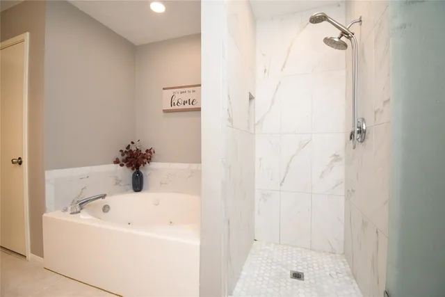a white bath tub sitting next to a white sink